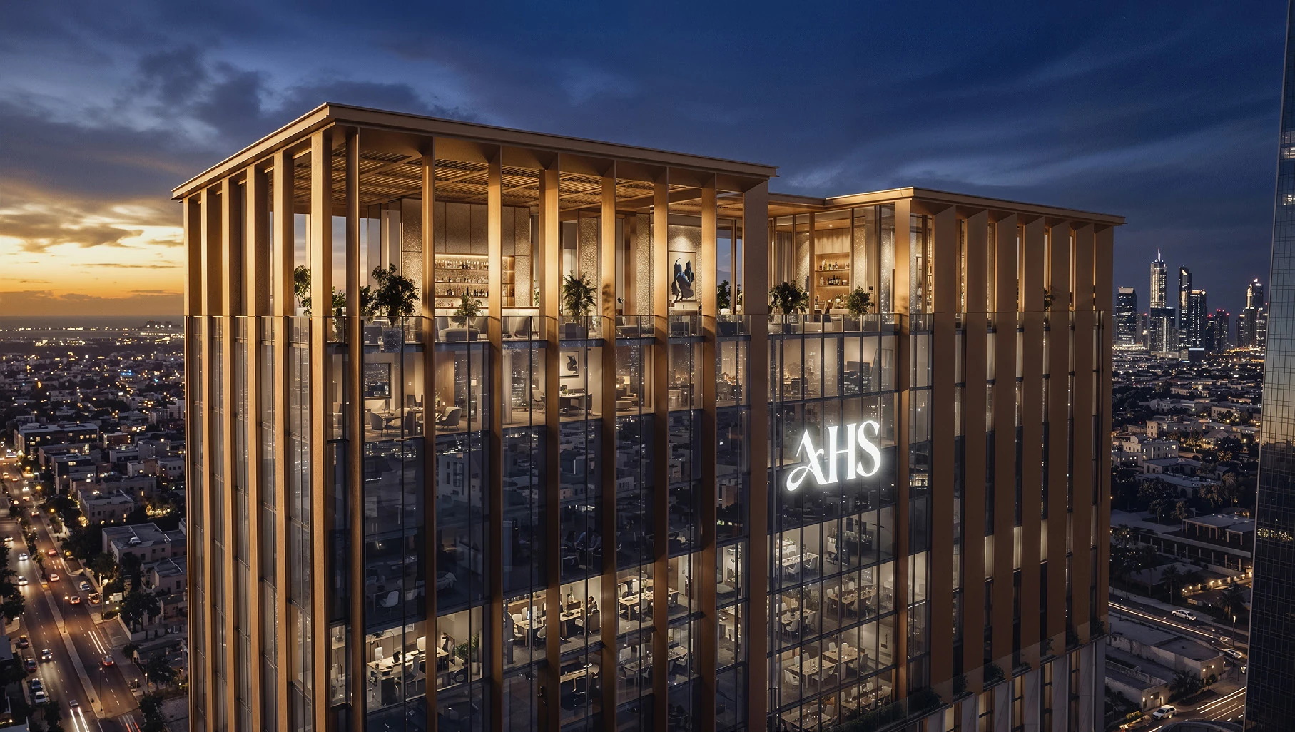 Illuminated crown and sky garden of AHS Twin Towers at dusk